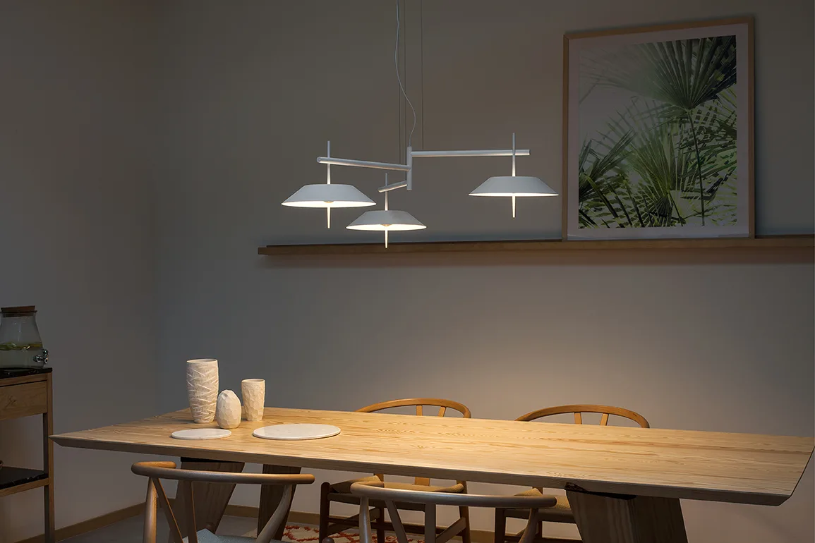 Vibia pendant lamp over a wooden dining table