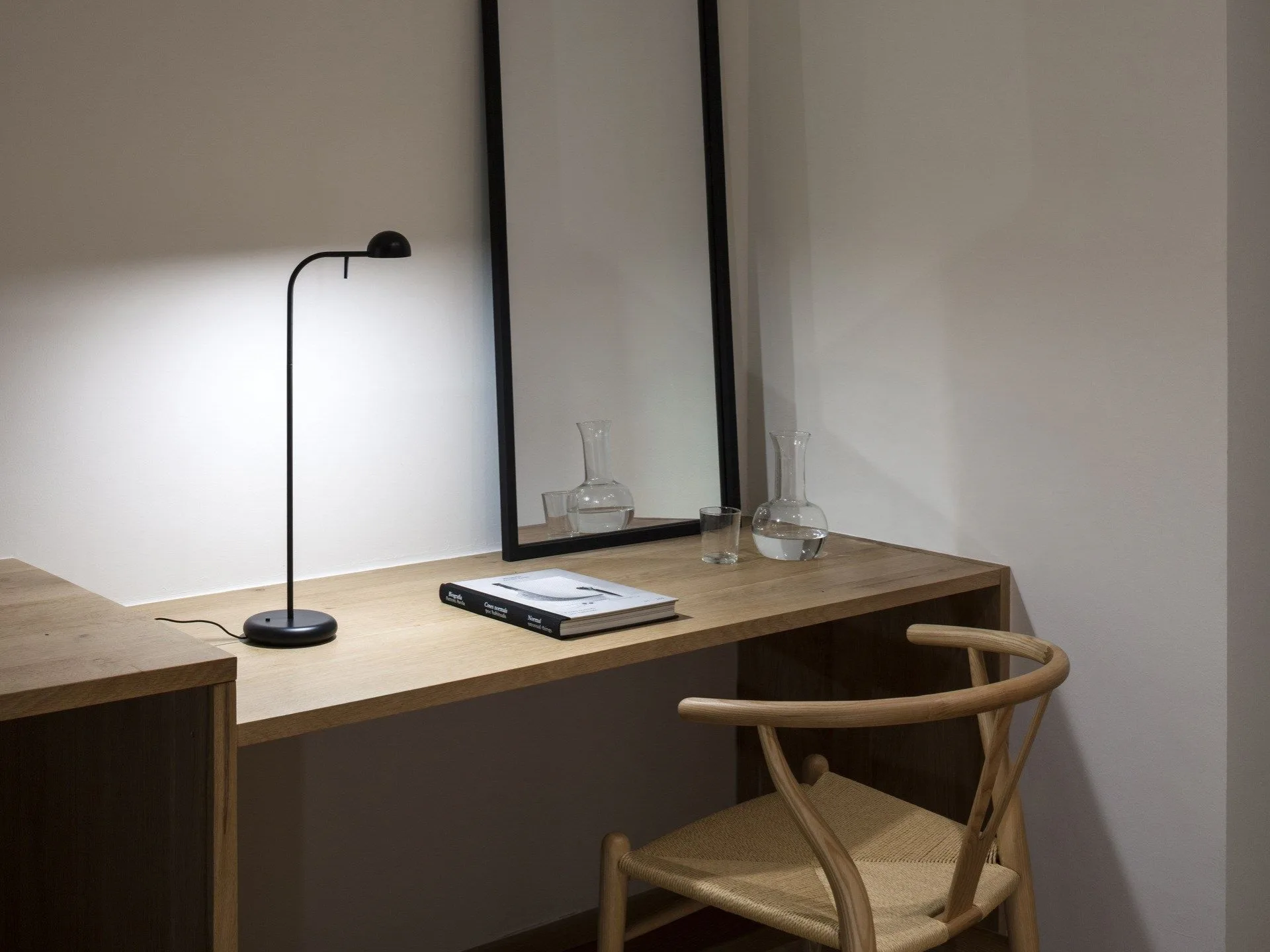 Vibia LED desk lamp on a wooden desk