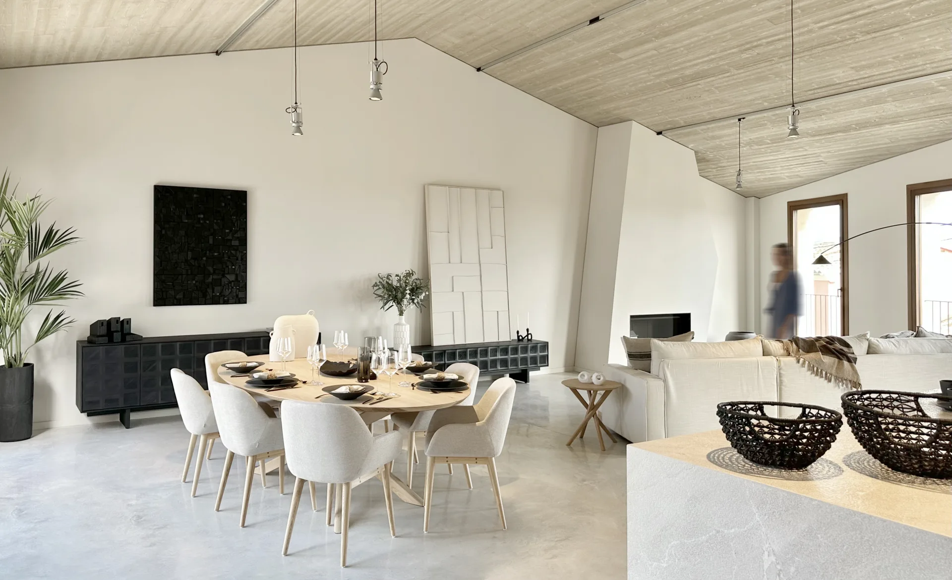 Living and dining room of a new-build home in Campanet with a wooden ceiling