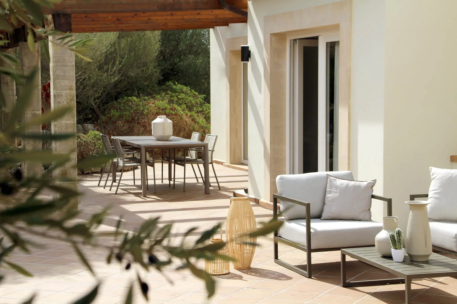 Covered terrace with outdoor furniture in a Mallorca home designed by Trends Studio